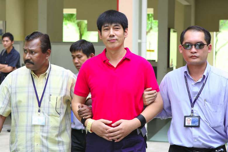 Wang zhijian being escorted by police at Yishun Triple Murder